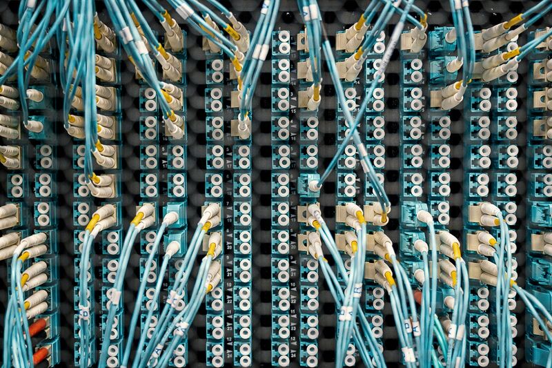 White and blue cables at the back of an Internet Server Rack